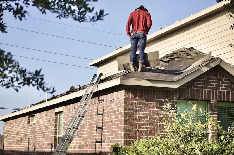 Professional roofer working on a residential roof in Littletown